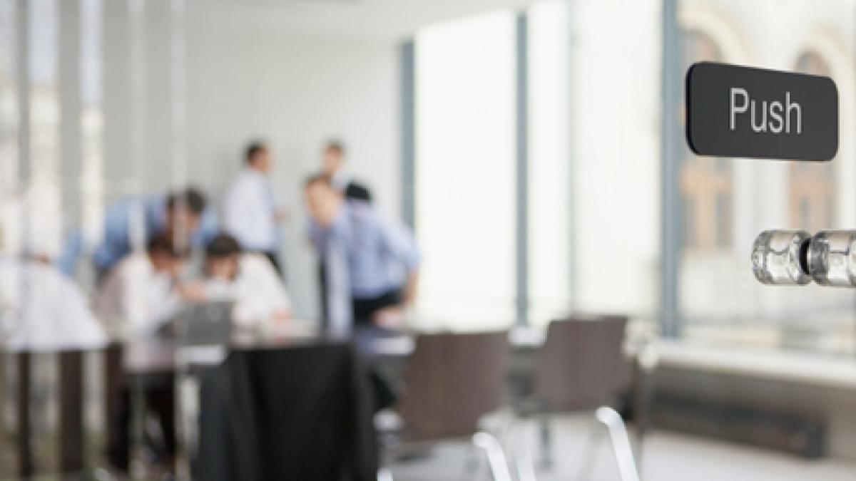 Office meeting behind glass doors