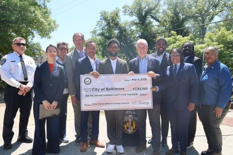 Congressman Mfume, Senator Van Hollen, Congressman Olszewski, and other officials with the ceremonial check