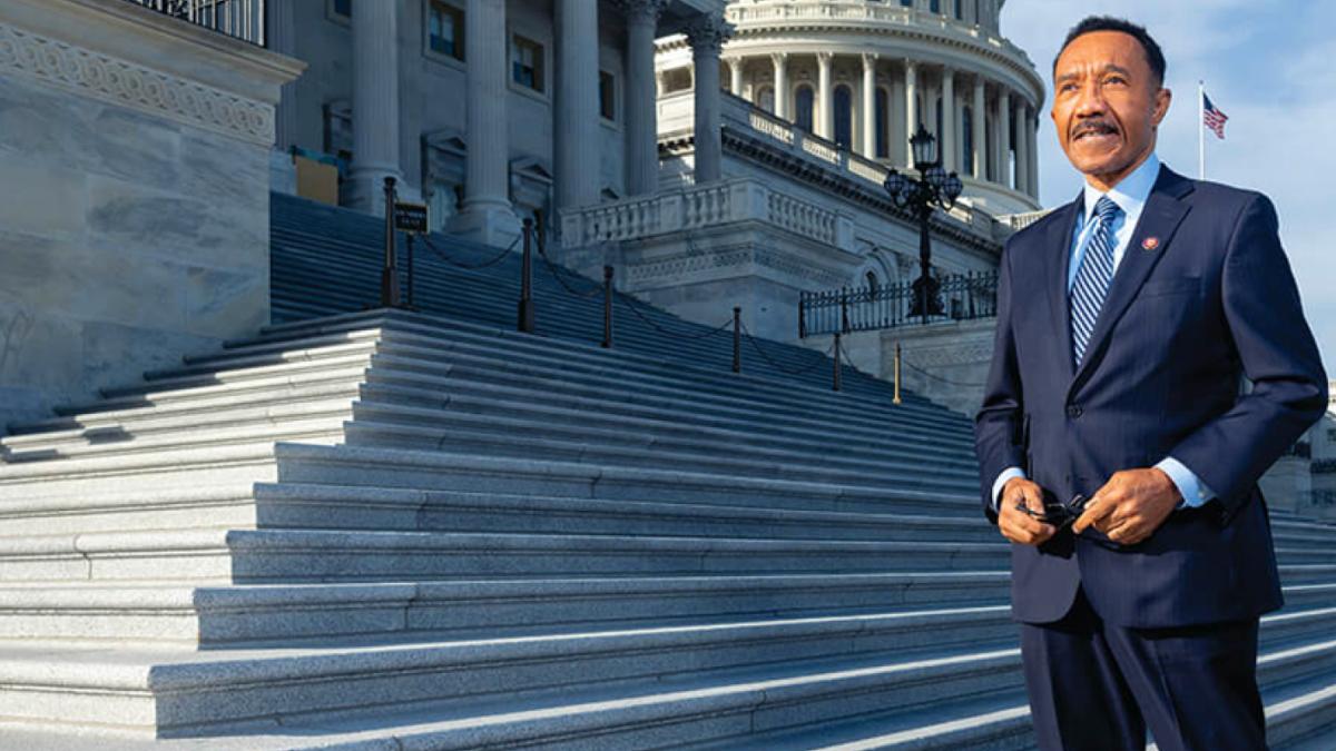 Rep Mfume standing in front of the Capitol Building looking off in distance.